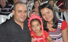 Os pais de Ana Lívia posam com a filha após sua apresentação