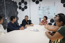 A servidora Camila em reunião com a equipe da Proginst