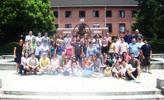 todos os brasileiros que participaram do curso em frente ao simbolo da Universidade de Shanghai