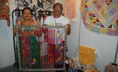 Dona Lindi e Mirtes Ramos, do Cooperartban, carregam tear por onde vão