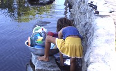Criança utiliza água do rio infectado pelo Schistosoma mansoni