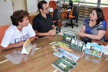 A vice-reitora Rachel Rocha recebe o calendário da equipe do MHN