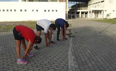 Participantes da caminhada se alongam antes do exercício
